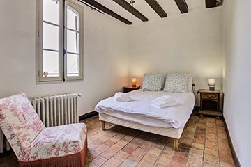 Chambre lumineuse avec poutres apparentes au Château de Juvardeil en Maine-et-Loire